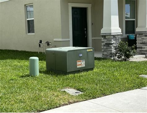 house electric green box|green utility box in yard.